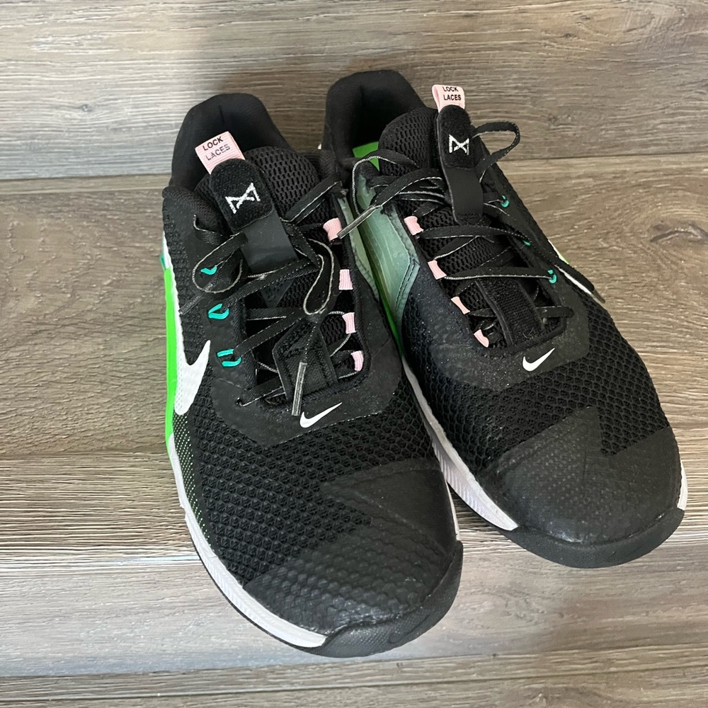 Nike Metcon 6. Size 9. Black with green and pink accents on the sole.